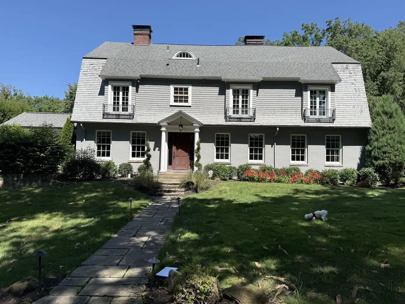 Sewickley Dutch Colonial home finished in gray James Hardie shingle siding with white trim, completed by Reliable Exteriors