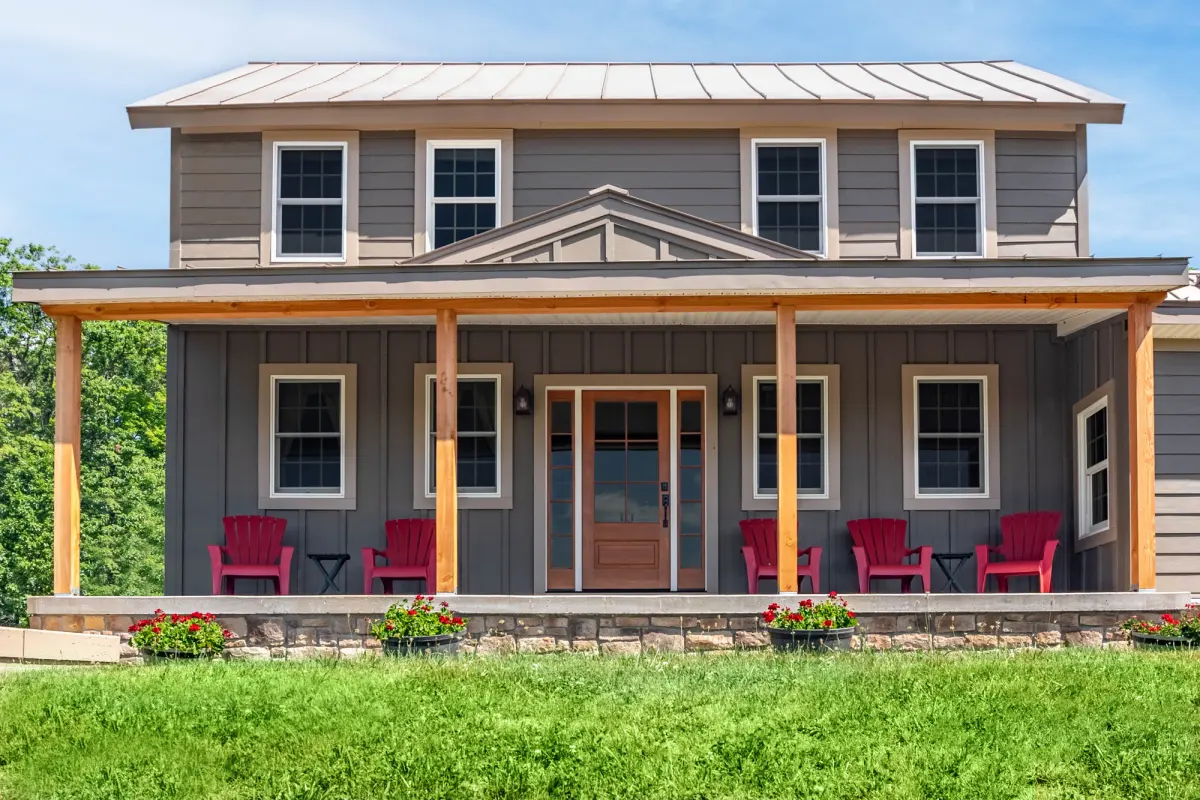 Farmhouse with James Hardie board-and-batten and lap fiber cement siding, covered porch, and standing-seam metal roof
